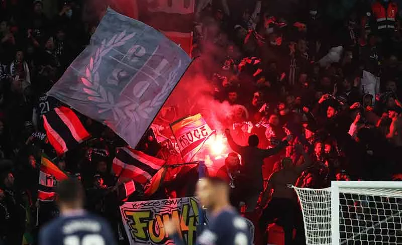 Fans van Paris Saint Germain vieren een doelpunt met vuurwerk